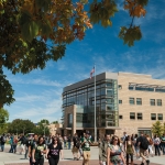 Students walk on the Colorado State University Plaza near the Computer Science Building as leaves begin to take on fall colors.